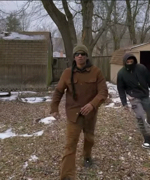 Man Wearing Sunglasses and Hat Walking in Woods
