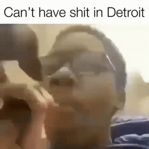 Man Wearing Sunglasses and Hat with Detroit Quote
