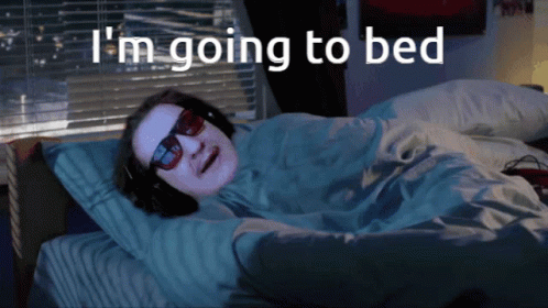 Man Wearing Sunglasses And Headphones Lying In Bed GIF