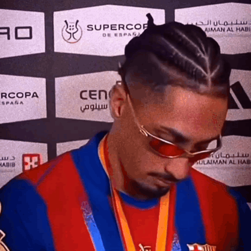 Man Wearing Sunglasses and Medal