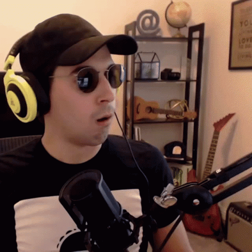 Man Wearing Sunglasses Headphones and Hat