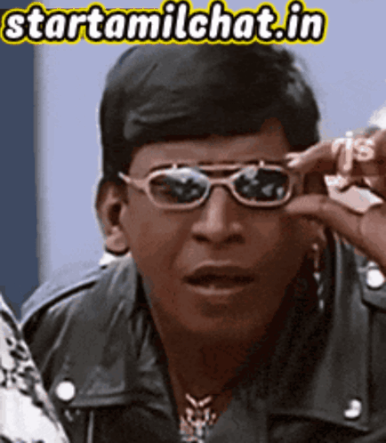 Man Wearing Sunglasses Holding Dollar Sign GIF