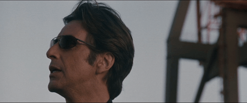 Man Wearing Sunglasses in Front of Building