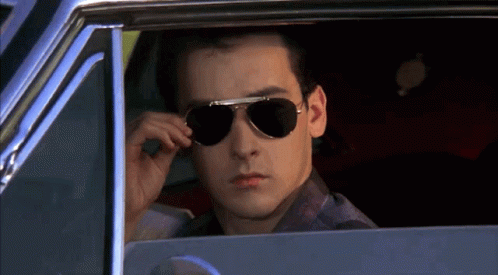 Man Wearing Sunglasses Looking Out Car Window