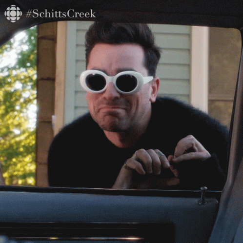 Man Wearing Sunglasses Looking Out Car Window GIF