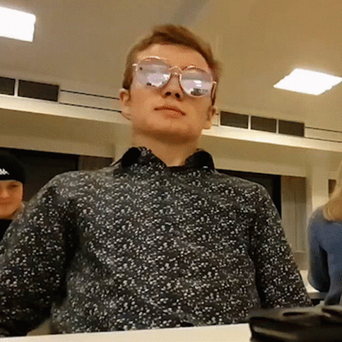 Man Wearing Sunglasses Sitting at Table