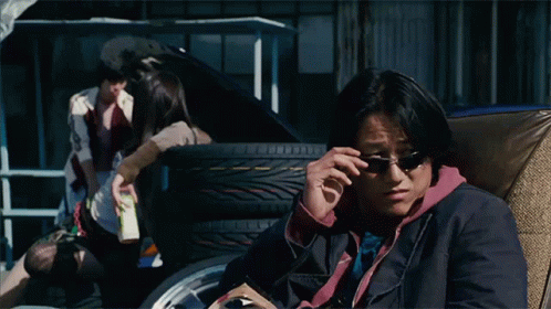 Man Wearing Sunglasses Sitting in Chair