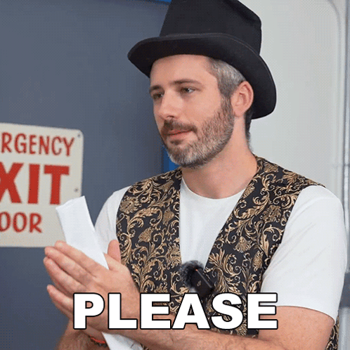 Man Wearing Top Hat Holding Paper in Front of Emergency Exit Sign