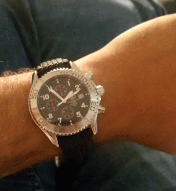 Man Wearing Watch in Front of Bicycle Wheel