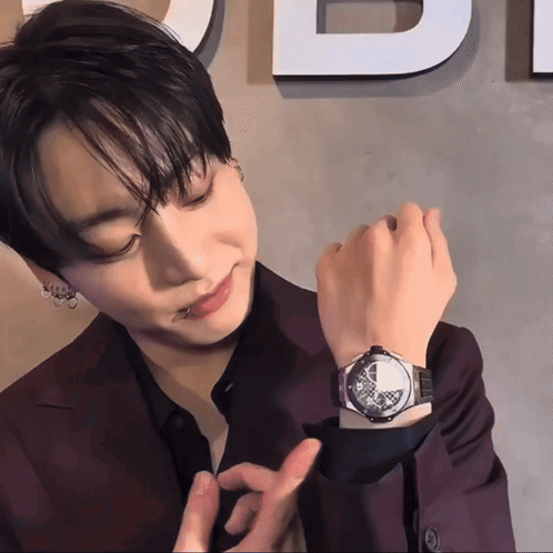 Man Wearing Watch In Front Of Di Sign GIF