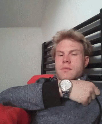 Man Wearing Watch Sitting in Bed