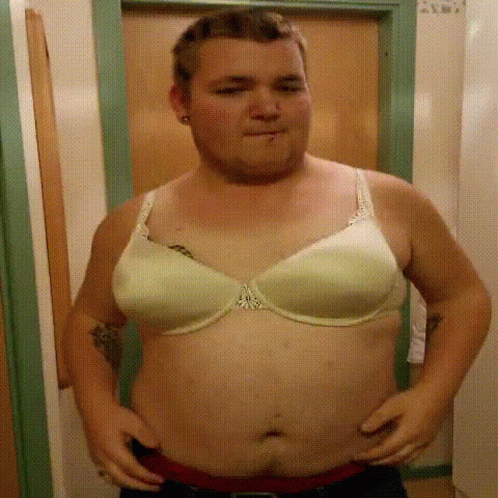 Man Wearing White Bra With Chest Tattoo