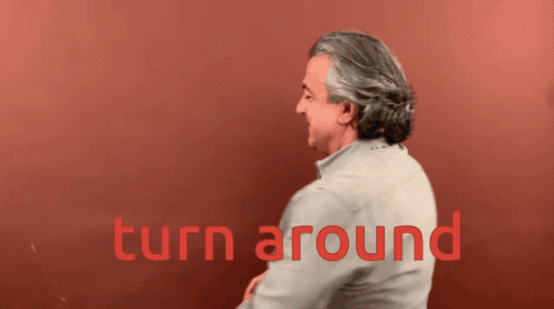 Man White Shirt Red Wall Saying Turn Around