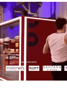 Man White Tank Top Red Wall Sony Text