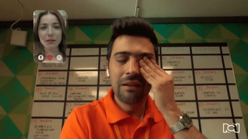 Man Wiping Eyes on Video Call With Woman and Semana Calendar