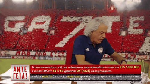 Man With Ante Teia Sign in Front of Crowd