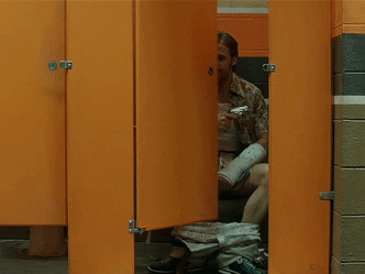Man With Arm Cast Sitting on Toilet