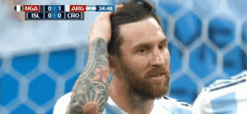 Man With Arm Tattoo Holding Head During Soccer Game