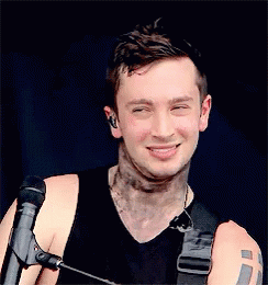 Man With Arm Tattoo Holding Microphone