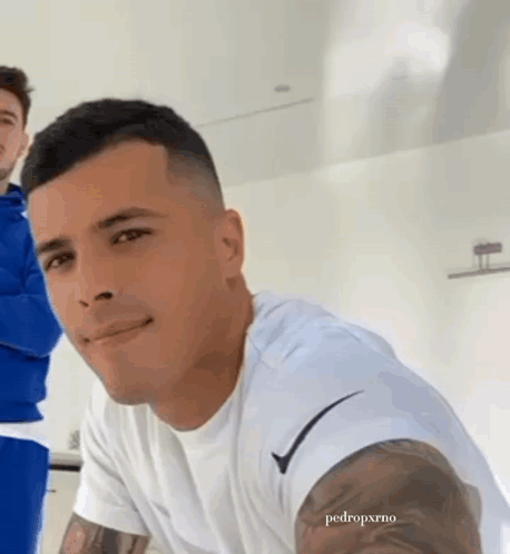 Man With Arm Tattoo in White Nike Shirt