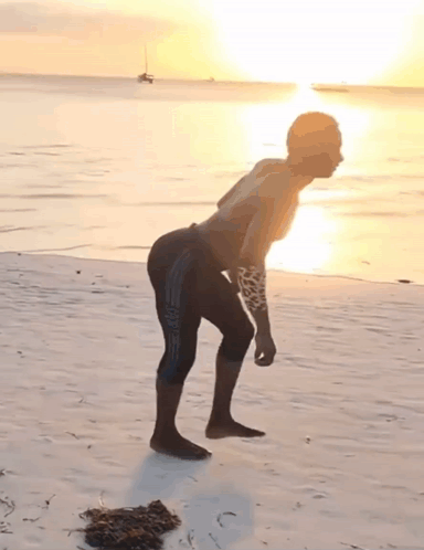 Man With Arm Tattoo On Beach GIF