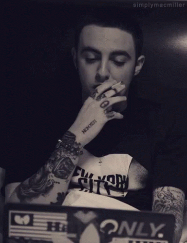 Man With Arm Tattoo Saying Mcmxcxii