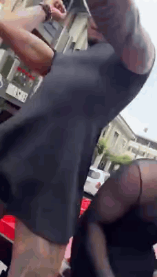 Man With Arm Tattoo Standing In Front Of Building GIF