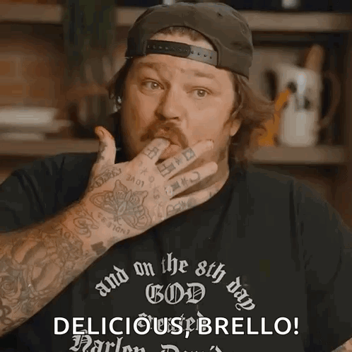 Man With Arm Tattoo Wearing Black Shirt That Says And on the 8th Day God