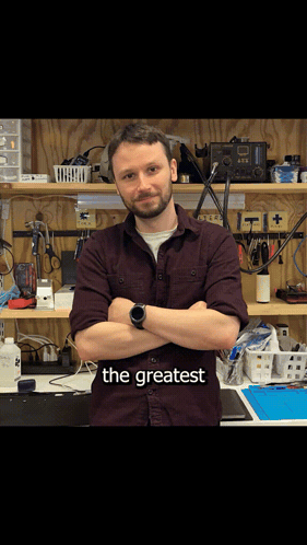 Man With Arms Crossed In Front Of Workbench Saying The Greatest GIF