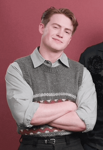 Man With Arms Crossed in Grey Vest