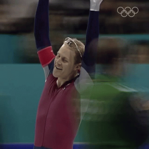 Man With Arms in Air in Red and Blue Outfit