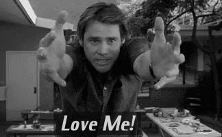 Man With Arms Outstretched and Love Me Sign