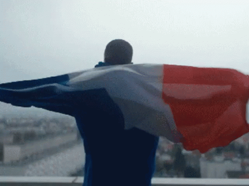 Man With Arms Outstretched Holding Flag GIF