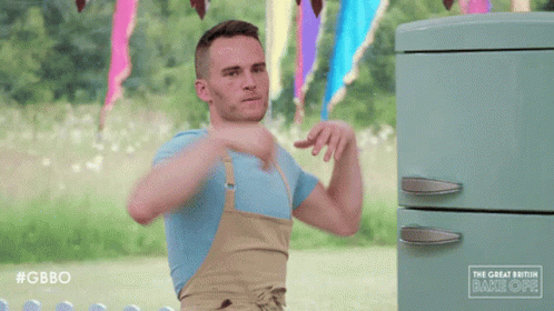Man With Arms Outstretched in Front of Green Refrigerator Saying Gbbo