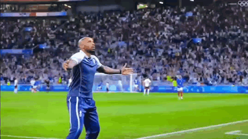 Man With Arms Outstretched on Soccer Field