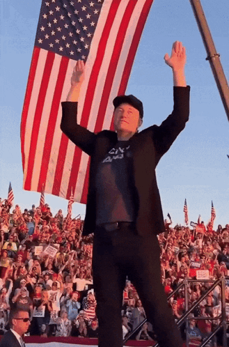 Man With Arms Up in Front of American Flag