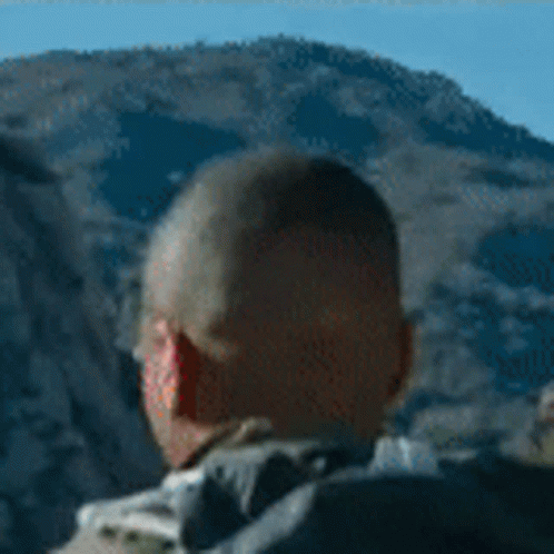 Man with Backpack in Front of Mountain