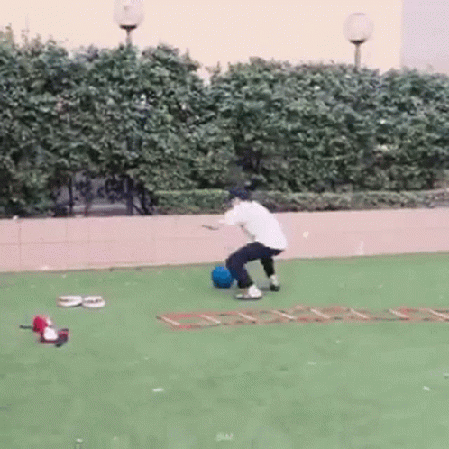 Man With Backpack Jumping Over Water Near Graffiti Building
