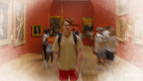 Man With Backpack Stands In Museum With Netflix Logo GIF