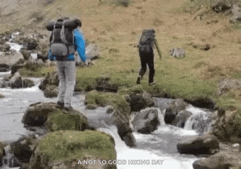 Man With Backpack Walking Across River GIF