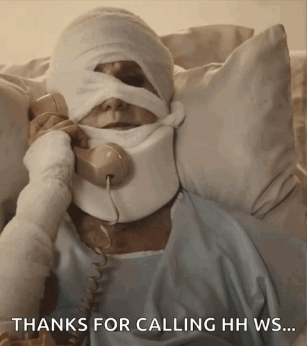 Man With Bandage On Head Talking On Phone GIF