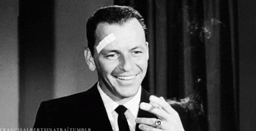 Man With Bandage Smiling And Smoking Cigar GIF