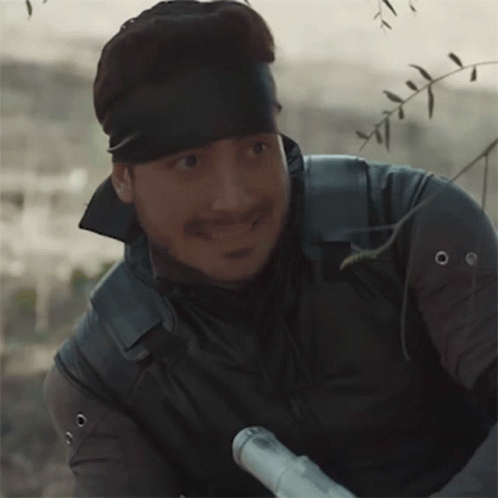 Man With Bandana Holding Rifle GIF