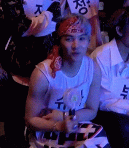 Man With Bandana Sitting In Crowd GIF