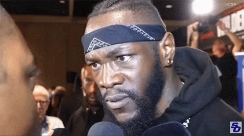 Man With Bandana Talking Into Microphone