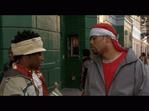 Man With Bandana Talking To Another Man GIF