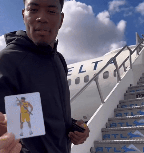 Man With Basketball Player Card in Front of Jet