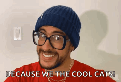 Man With Beanie and Glasses Smiling Says Because We the Cool Cats