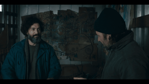 Man With Beard and Beanie Talking to Another Man