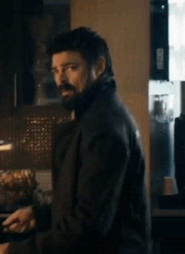 Man With Beard and Black Jacket in Kitchen